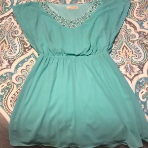 Mint green dress with embodiment neck line.